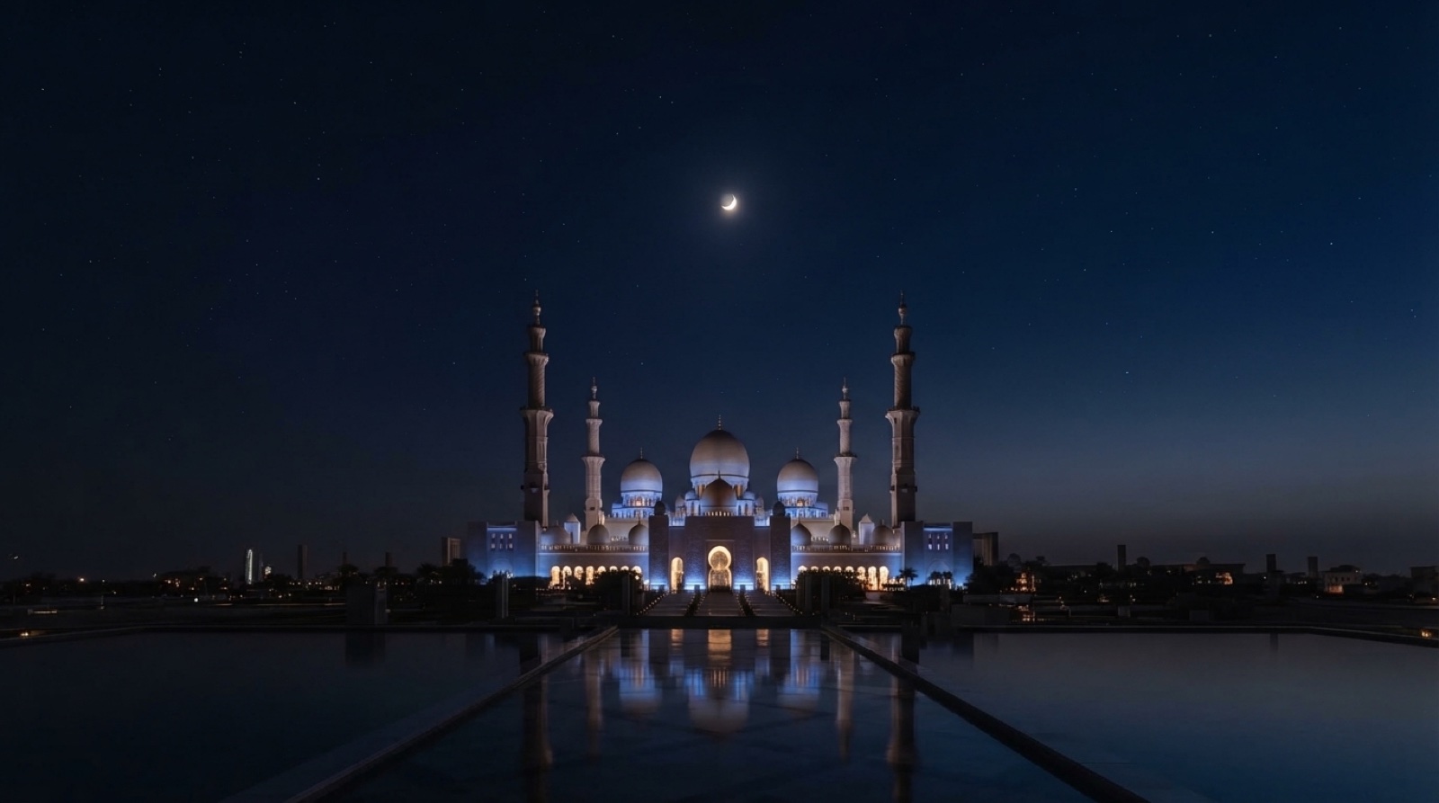 Illuminated mosque under a dark night sky with a crescent moon.